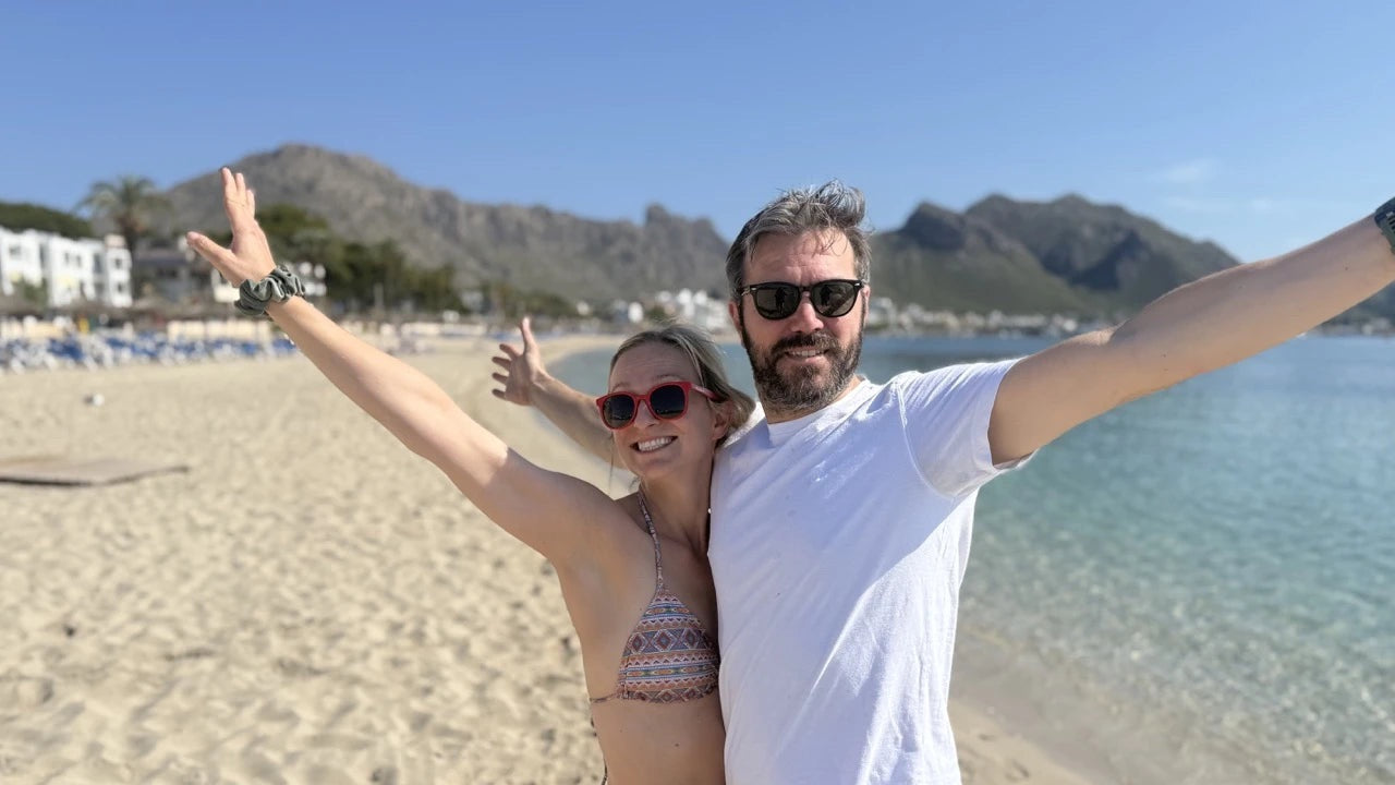 Man and woman on the beach wearing BioSunnies