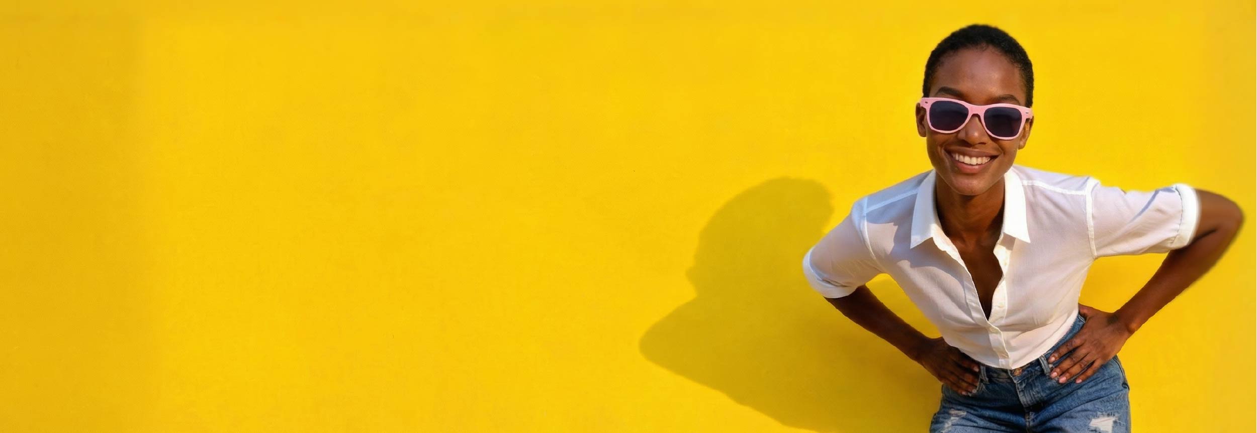 Woman wearing Biosunnies sunglasses and a white shirt against a yellow background