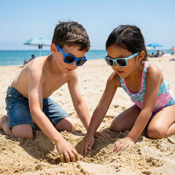 Two children playing in the sand on a beach with BioSunnies sunglasses on.