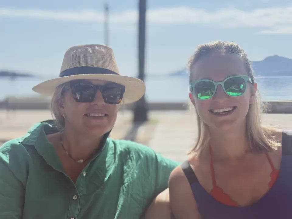 Two women laughing by the sea